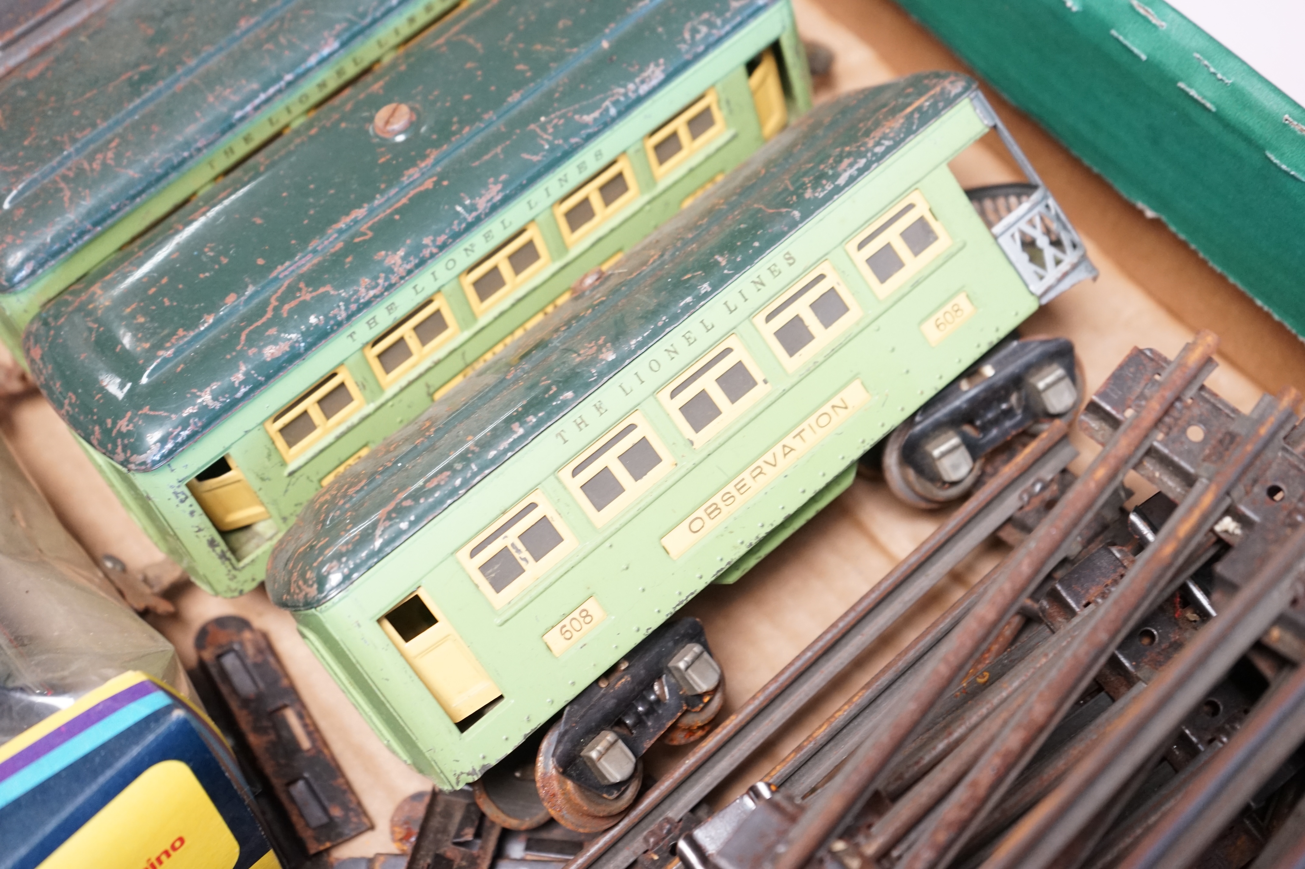 A Lionel 3-rail electric US outline tender locomotive, together with three tinplate bogie Pullman Cars and a small quantity of Hornby 3-rail track sections, a Hornby tunnel and a scratch-built Through railway station